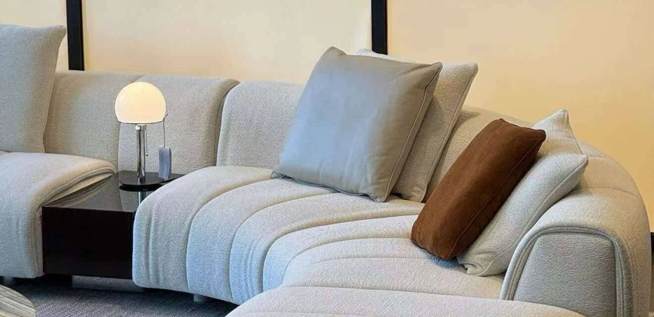 Ivory curved sectional sofa in minimal showroom