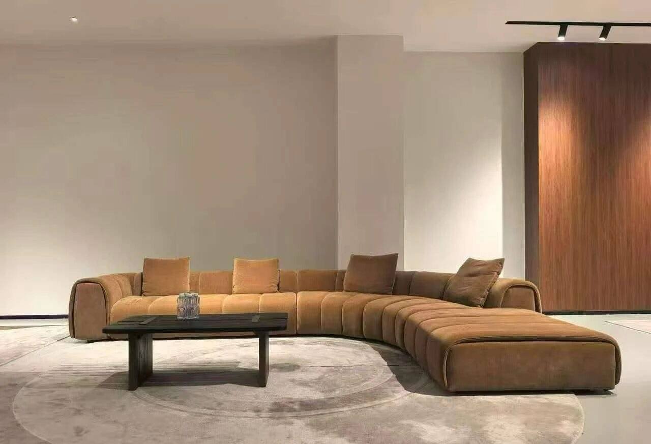 Caramel curved modular sofa with chaise in showroom